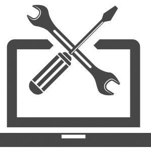 Laptop with screwdriver and wrench