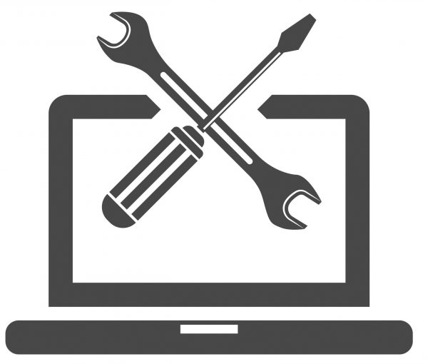 Laptop with screwdriver and wrench